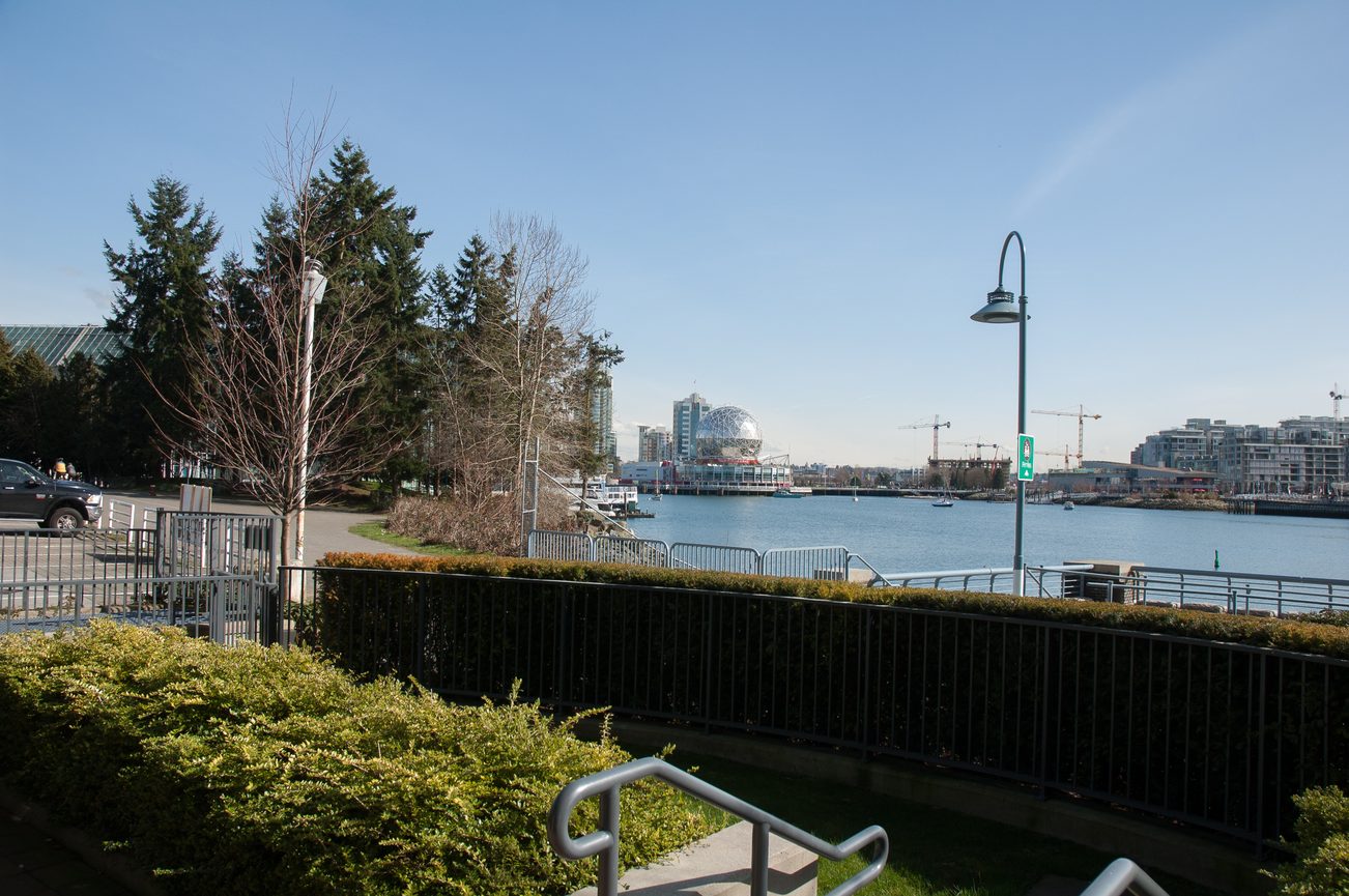 Bright living room with a stunning city view and waterfront access. - 100-9 Smithe Mews, Vancouver Downtown