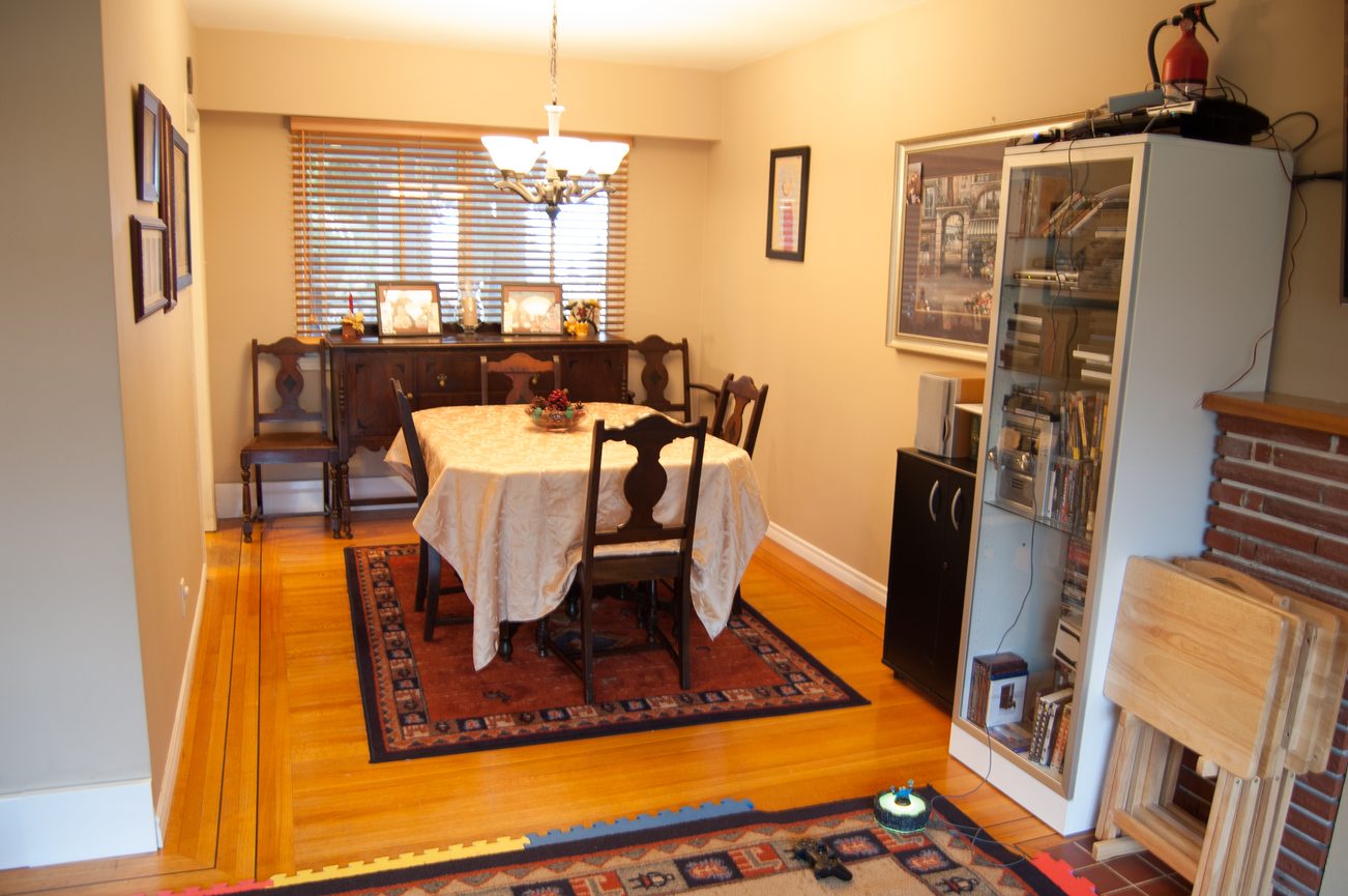 Furnished dining room with hardwood floors, a round table, and a wooden buffet. - MAIN - 451 East Keith Road, North Vancouver