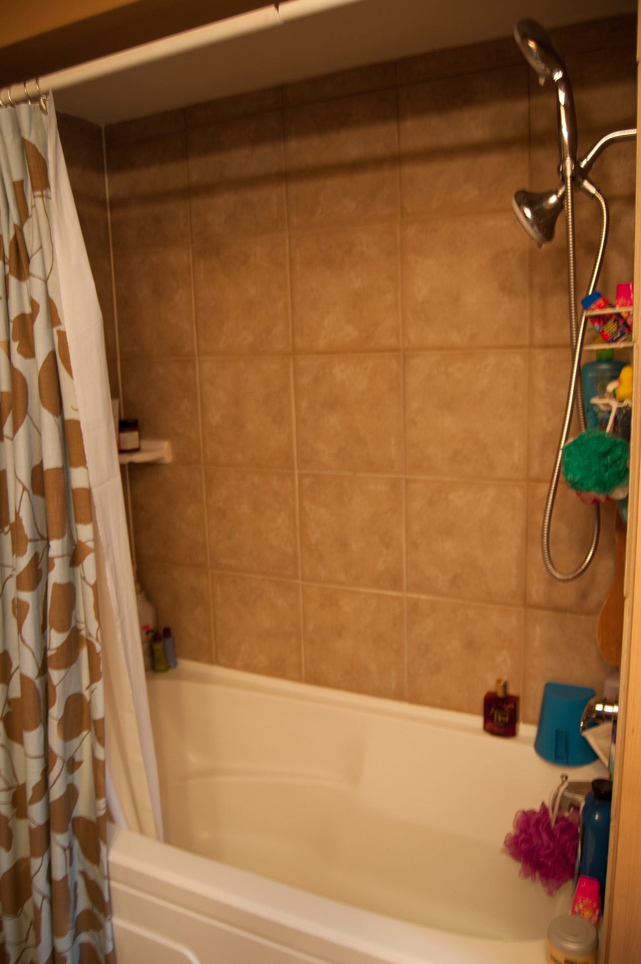 Bathroom with tiled walls, bathtub, and shower curtain. - MAIN - 451 East Keith Road, North Vancouver