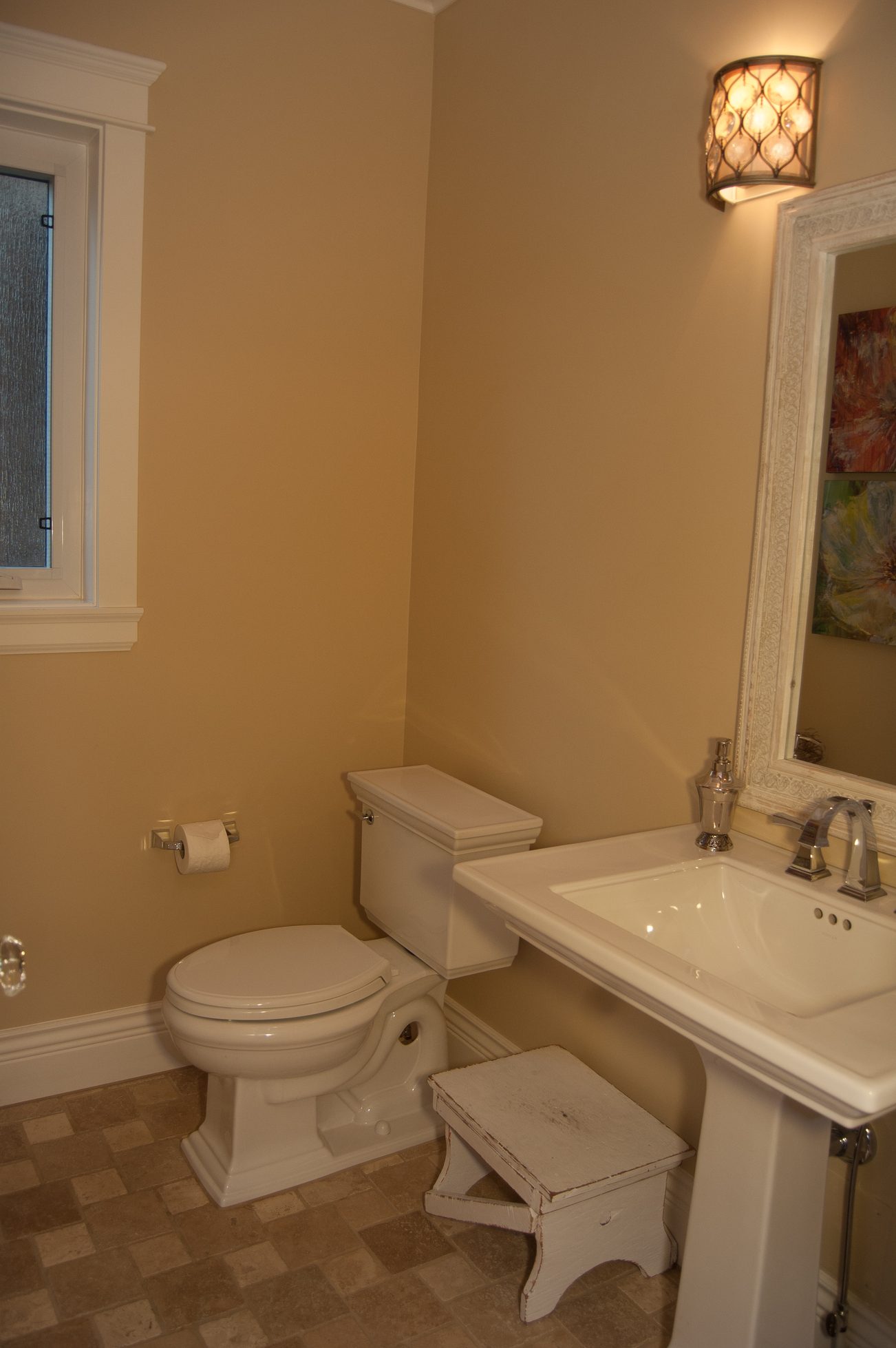 Bright bathroom with white sink and toilet, checkered floor, wall sconce lighting. - 186 West 23rd Ave, Vancouver West Side