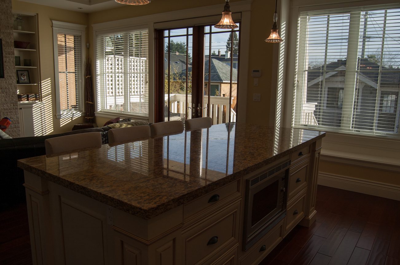 Bright kitchen with granite countertops, hardwood floors, and a city view. - 186 West 23rd Ave, Vancouver West Side