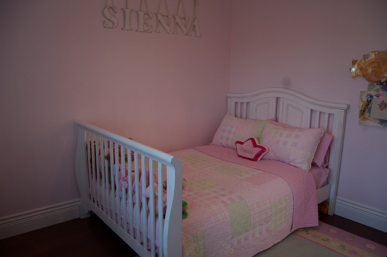 Bright bedroom with pink walls, white furniture, and a "Princess" pillow. - 186 West 23rd Ave, Vancouver West Side