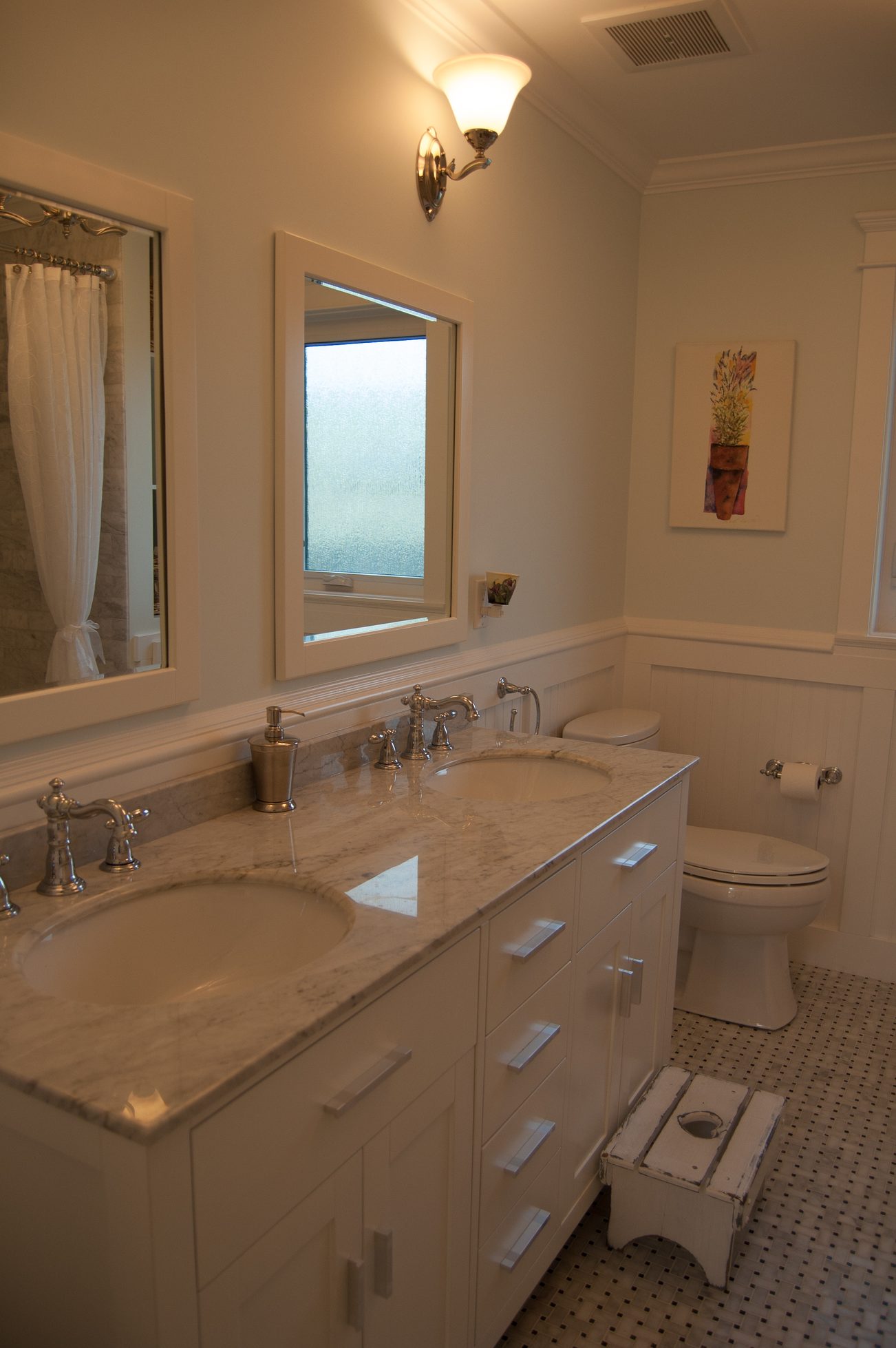 Bright bathroom with marble countertops and white cabinetry. - 186 West 23rd Ave, Vancouver West Side