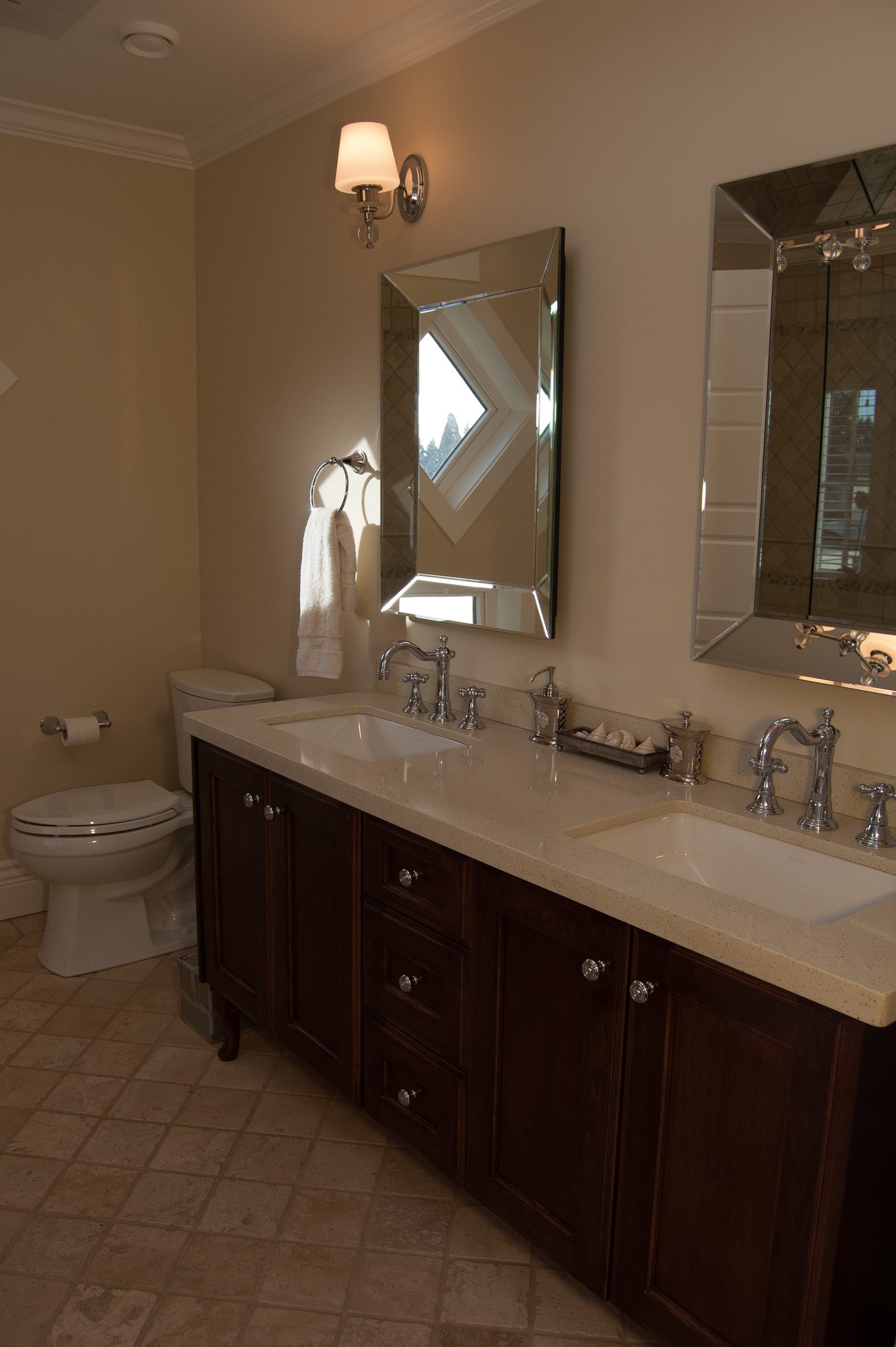 Bathroom with double sinks, dark wood cabinets, and a large mirror. - 186 West 23rd Ave, Vancouver West Side