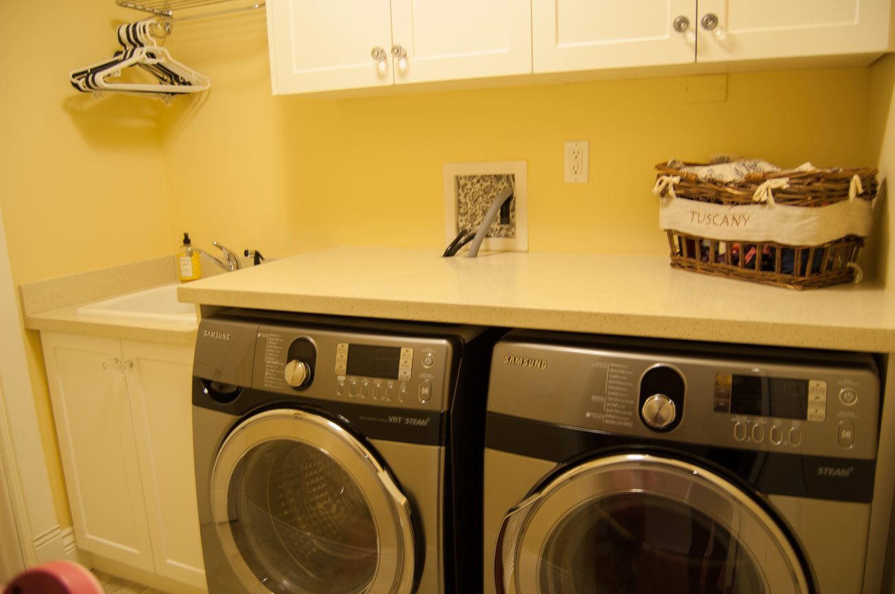 Laundry room with white countertops and a Samsung washer and dryer set. - 186 West 23rd Ave, Vancouver West Side