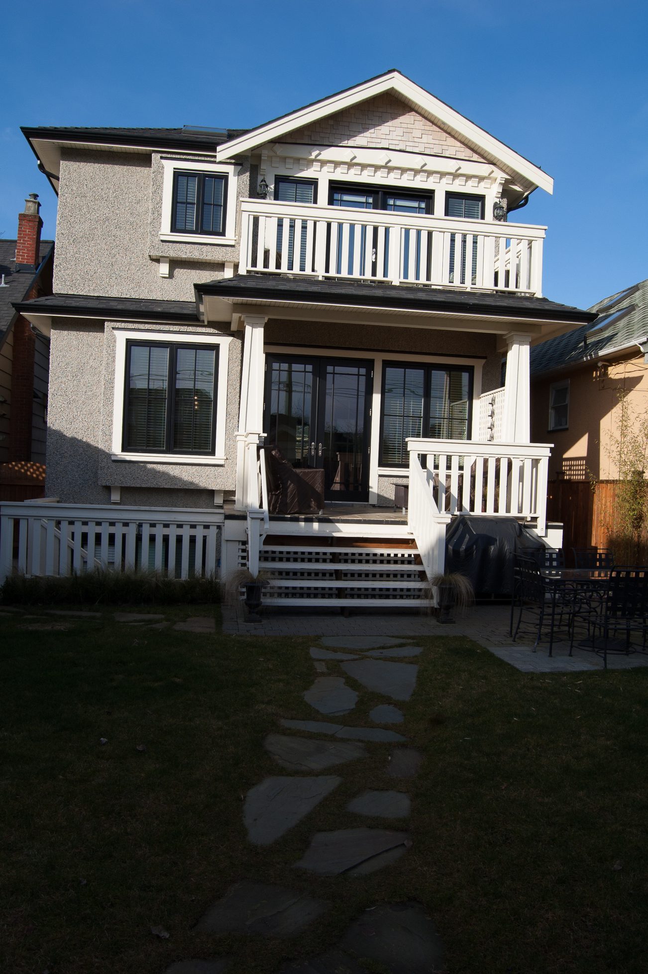 Bright 3-bedroom house with a spacious deck and white railings, perfect for relaxation. - 186 West 23rd Ave, Vancouver West Side
