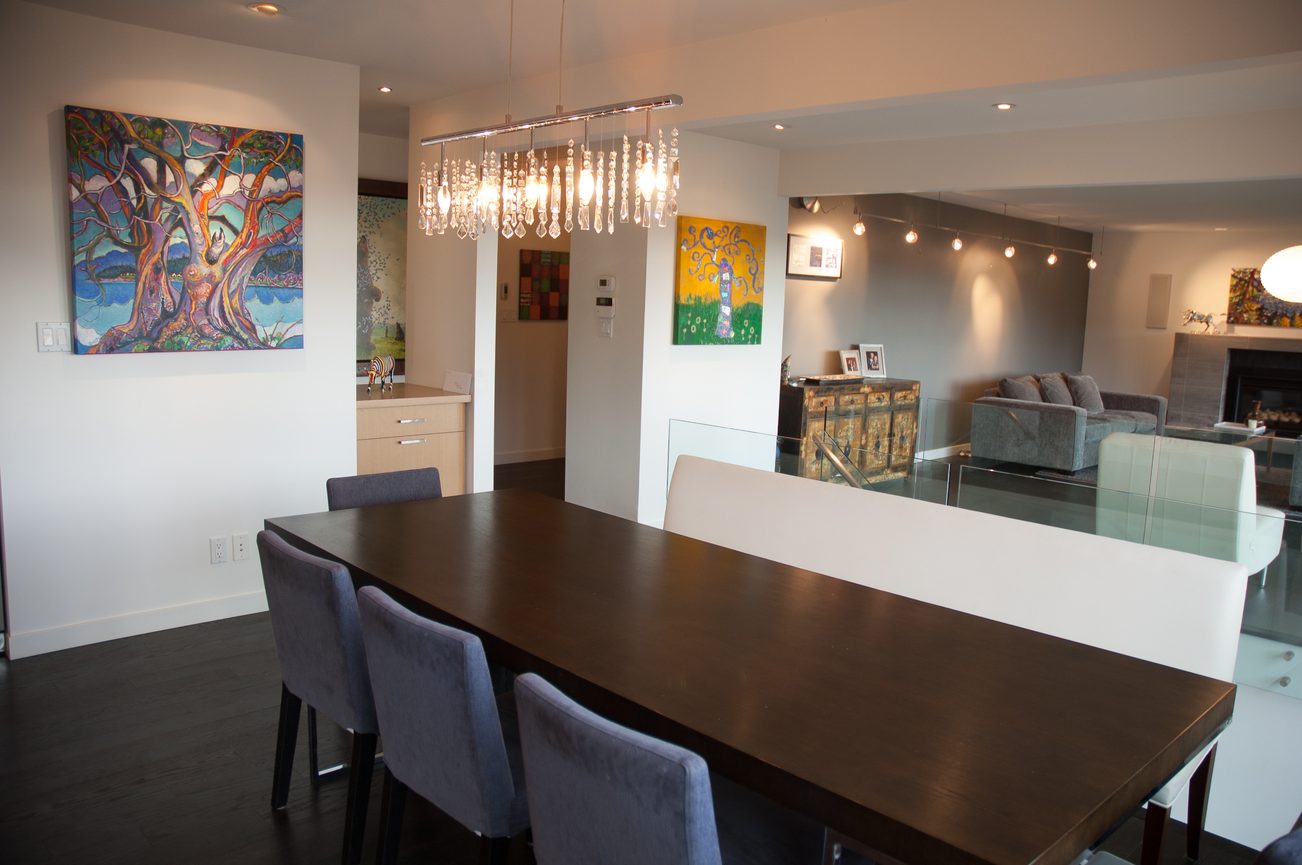 Furnished dining area with modern chandelier and colorful artwork. - 3925 Viewridge Place, West Vancouver