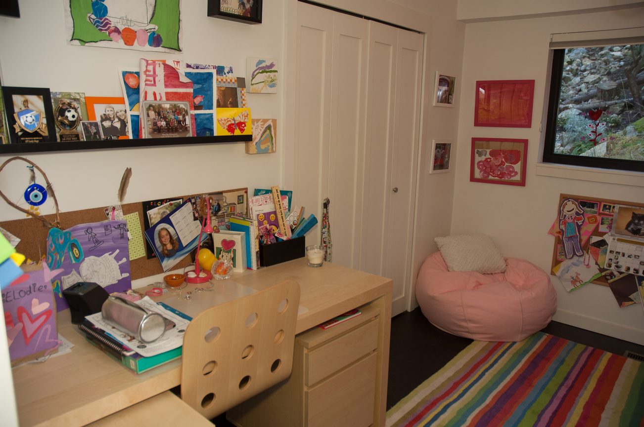Bright bedroom with colorful artwork, bean bag chair, and desk area. - 3925 Viewridge Place, West Vancouver