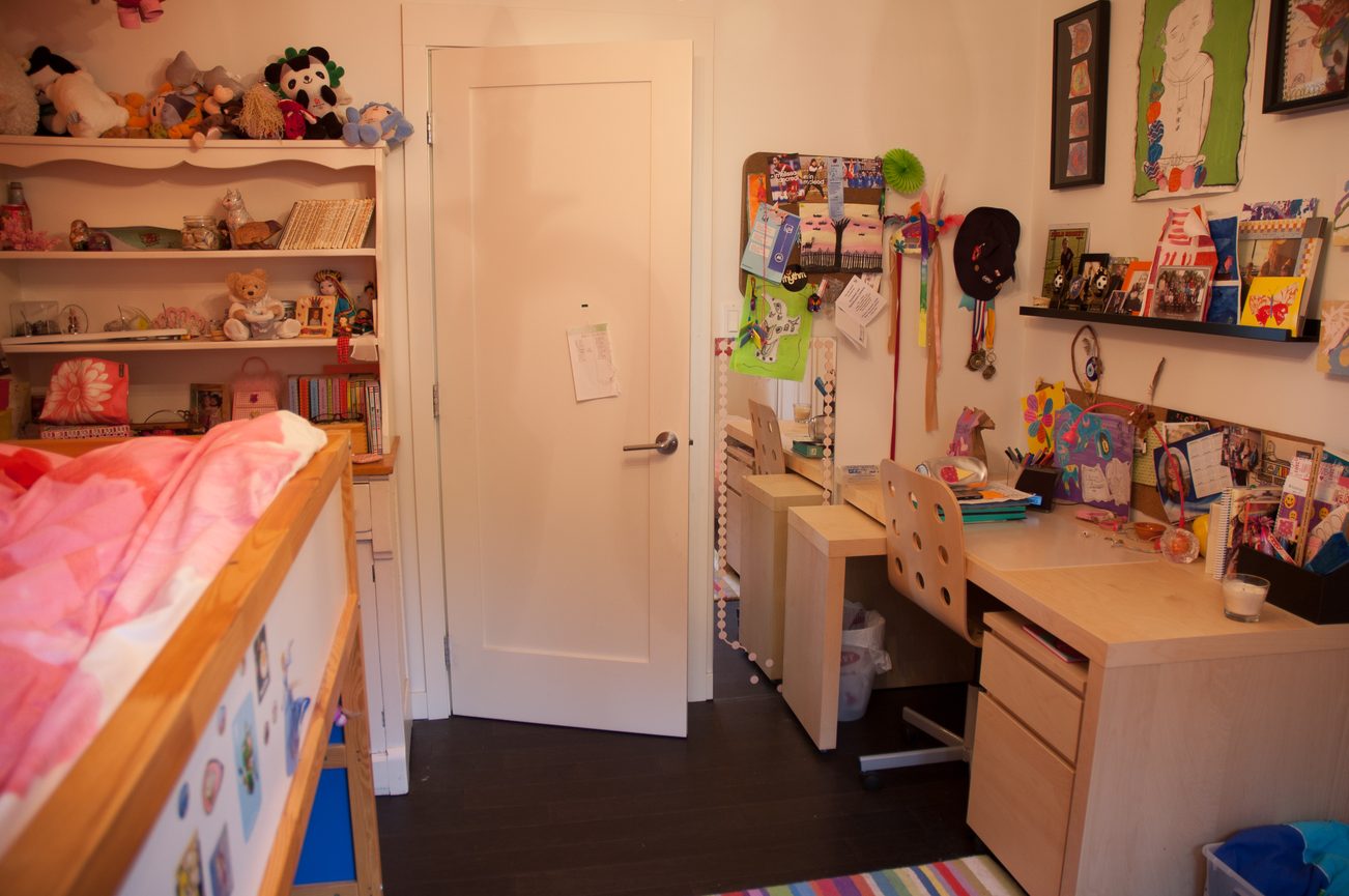 Bright child's bedroom with bunk bed, desk, and shelves filled with toys and artwork. - 3925 Viewridge Place, West Vancouver