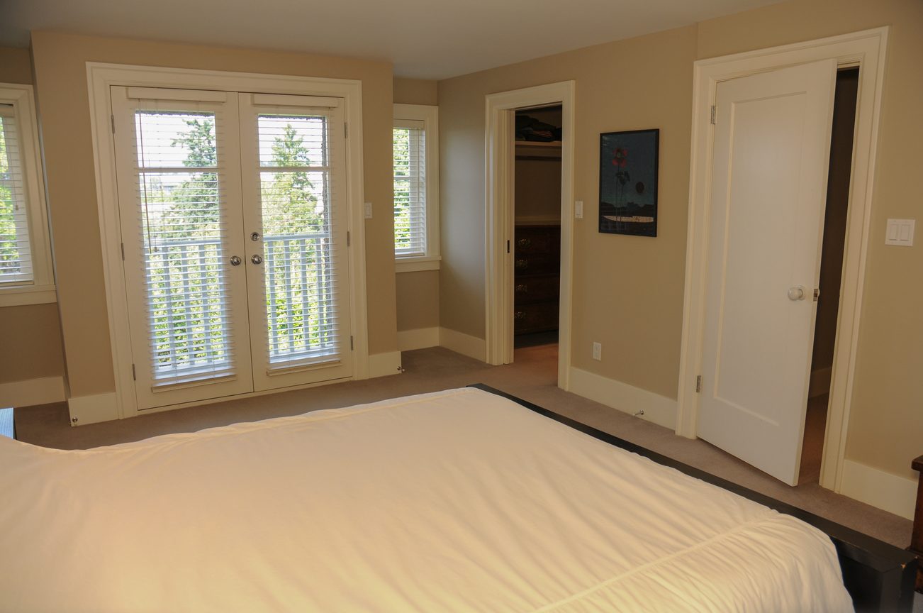 Spacious bedroom with French doors, closet, and natural light. - 2037 Quilchena Crescent, Vancouver West Side