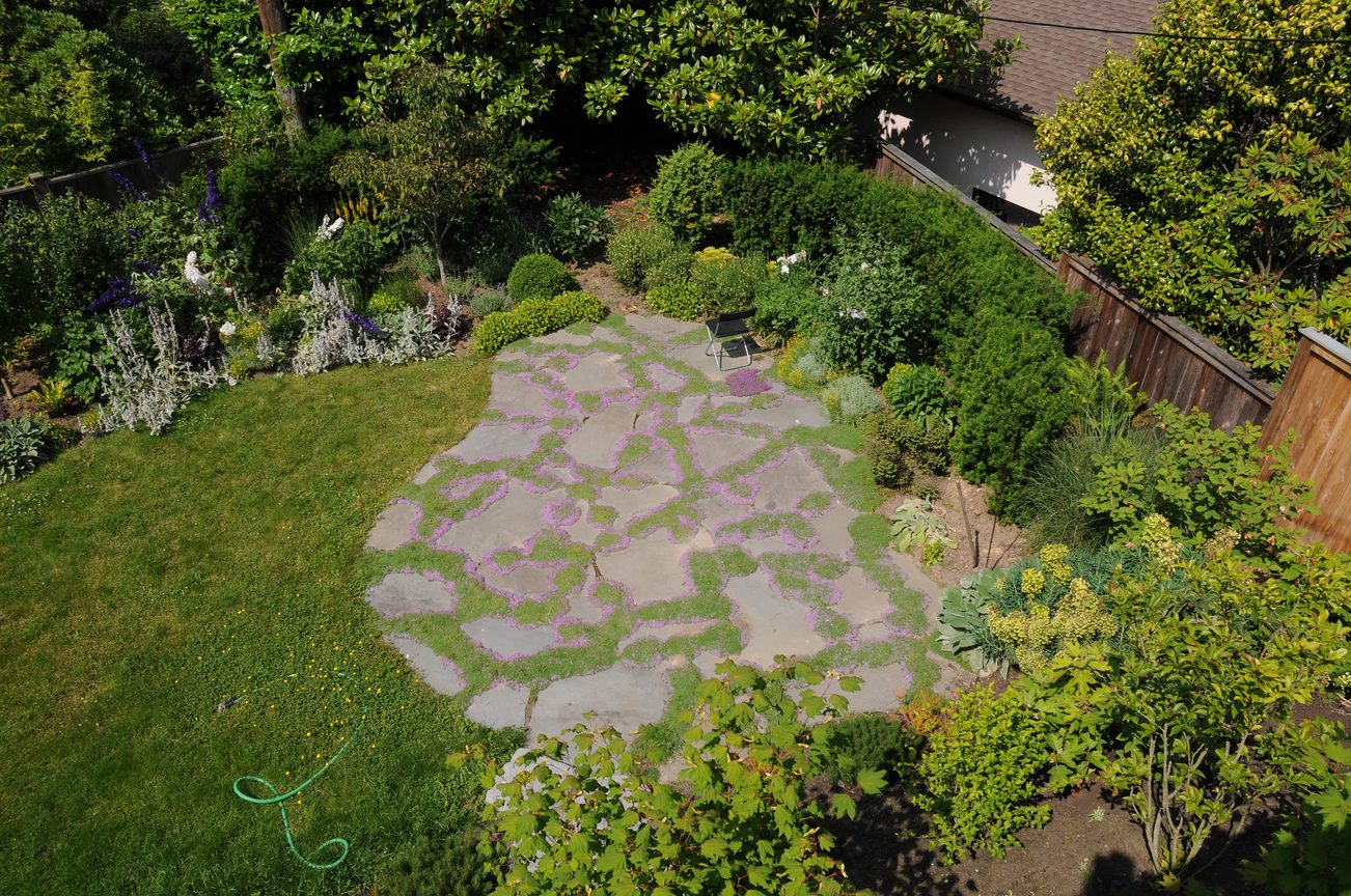 Furnished backyard with stone pathway and lush greenery. - 2037 Quilchena Crescent, Vancouver West Side