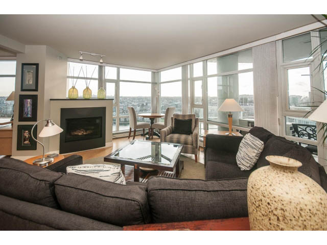 Furnished living room with city view and modern decor. - 2901 - 1199 Marinaside, Vancouver Downtown