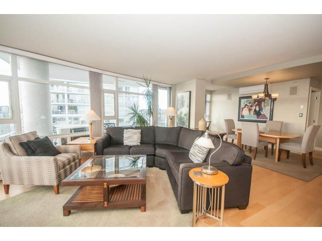 Furnished living room with hardwood floors, city view, and modern decor. - 2901 - 1199 Marinaside, Vancouver Downtown