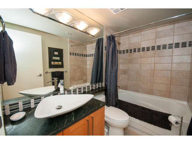 Furnished bathroom with marble countertop and modern fixtures. - 2901 - 1199 Marinaside, Vancouver Downtown
