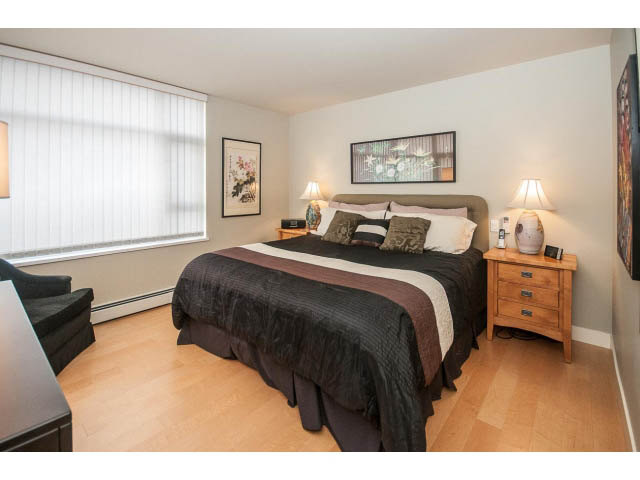 Furnished 1-bedroom + den with hardwood floors, cozy bedding, and artwork. - 2901 - 1199 Marinaside, Vancouver Downtown