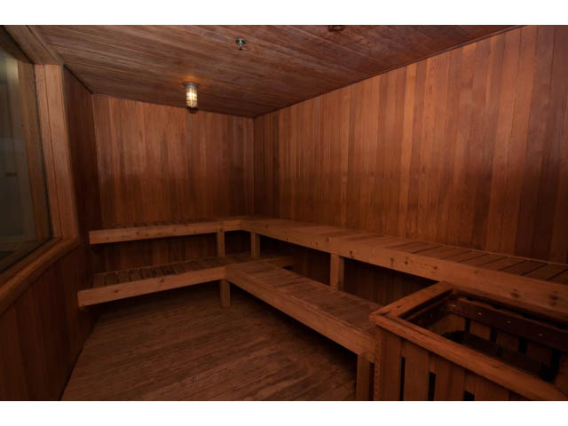 Spacious, well-lit sauna with wooden benches and a cozy ambiance. - 2901 - 1199 Marinaside, Vancouver Downtown