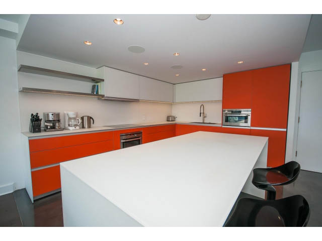 Bright kitchen with white countertops and orange cabinets, modern design. - 806 - 518 Moberly Rd, Vancouver West Side