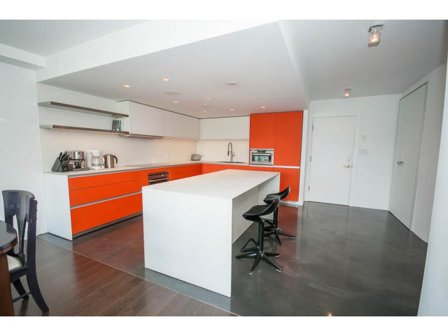 Bright kitchen with orange cabinets and white countertops, hardwood floors, and modern design. - 806 - 518 Moberly Rd, Vancouver West Side