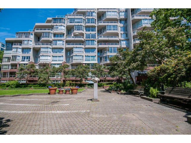 Furnished patio with potted plants and steps leading up to a multi-level condo building. - 806 - 518 Moberly Rd, Vancouver West Side