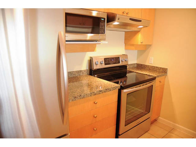 Bright kitchen with granite countertops and stainless steel appliances. - 606-1228 Marinaside Crescent, Vancouver Downtown