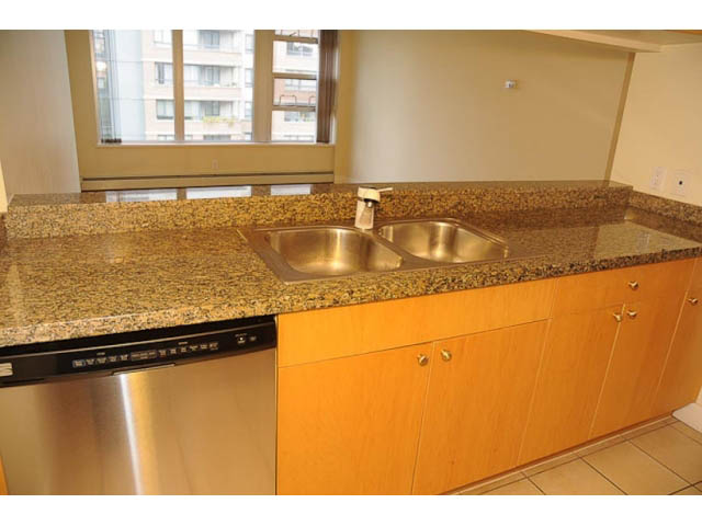 Bright kitchen with granite countertops and stainless steel sink, city view through window. - 606-1228 Marinaside Crescent, Vancouver Downtown