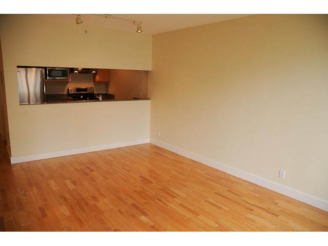 Bright kitchen with stainless steel appliances and hardwood floors. - 606-1228 Marinaside Crescent, Vancouver Downtown