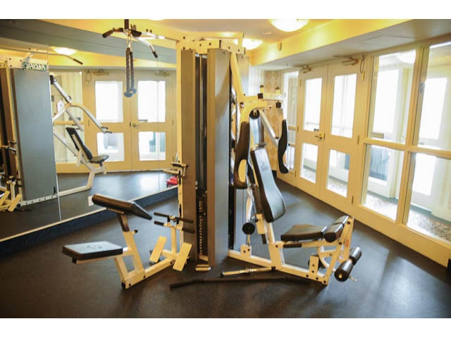 Furnished gym with weight machines and windows. - 606-1228 Marinaside Crescent, Vancouver Downtown