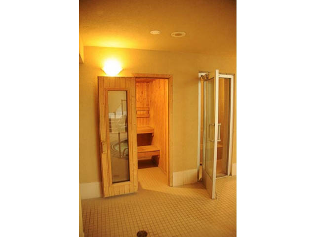 Spacious bathroom with wooden accents and tiled floor. - 606-1228 Marinaside Crescent, Vancouver Downtown
