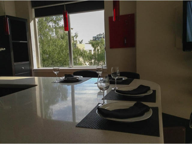 Furnished dining area with modern decor, city view, and sleek countertops. - 501 - 1251 Cardero Street, Vancouver Downtown