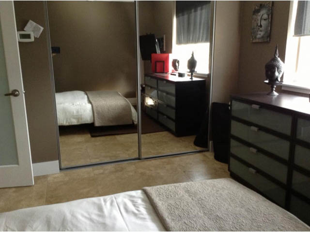 Bright bedroom with modern furniture and a large window. - 501 - 1251 Cardero Street, Vancouver Downtown