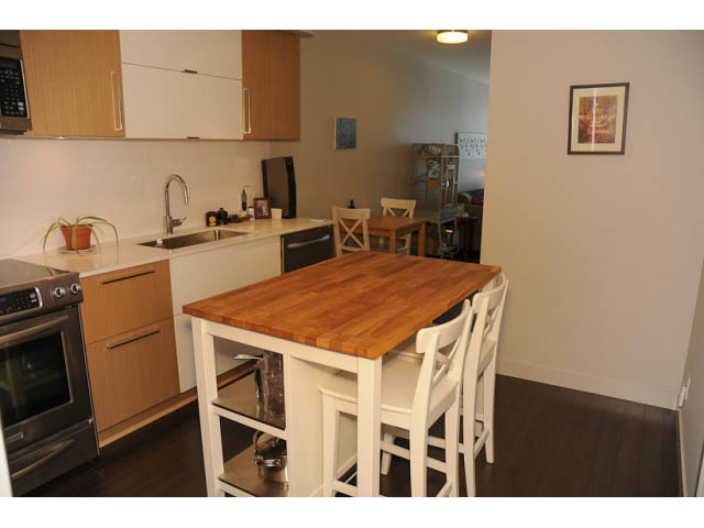 Furnished kitchen with wooden countertops and hardwood floors. - 306-215 East 33rd Ave, Vancouver East Side