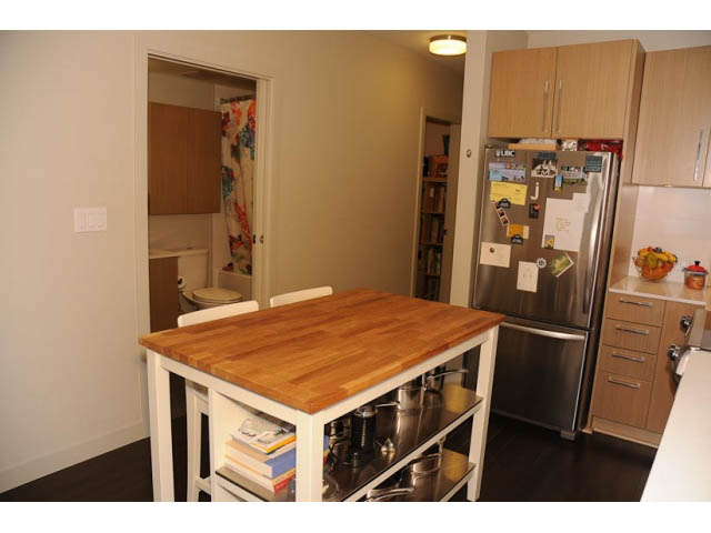 Bright kitchen with wooden countertops and stainless steel appliances, hardwood floors. - 306-215 East 33rd Ave, Vancouver East Side