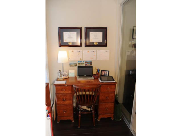 Furnished 1-bedroom condo with wooden desk, framed certificates, and hardwood floors. - 306-215 East 33rd Ave, Vancouver East Side