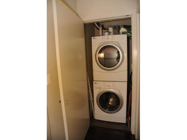 Laundry room with stacked washer and dryer, small closet above. - 306-215 East 33rd Ave, Vancouver East Side
