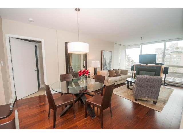 Furnished living room with hardwood floors, city view, and modern decor. - 508 - 1675 West 8th Ave, Vancouver West Side