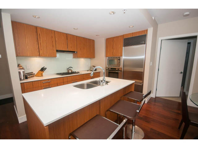 Furnished kitchen with white countertops and hardwood floors. - 508 - 1675 West 8th Ave, Vancouver West Side