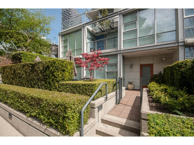 Furnished living room with modern furnishings and city view. - 106 - 633 Kinghorne Mews, Vancouver Downtown