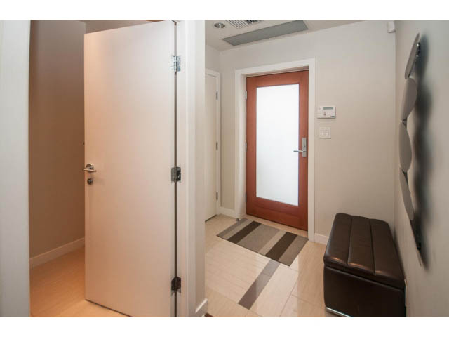 Furnished entryway with wooden flooring and a modern door. - 106 - 633 Kinghorne Mews, Vancouver Downtown
