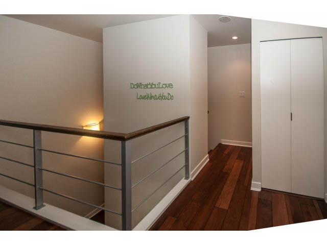 Furnished living room with modern decor, hardwood floors, and a minimalist design. - 106 - 633 Kinghorne Mews, Vancouver Downtown