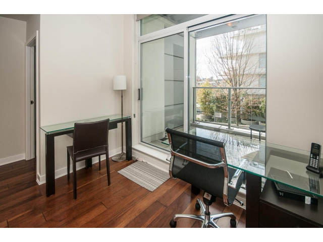 Furnished office with glass desk, hardwood floors, and city view. - 106 - 633 Kinghorne Mews, Vancouver Downtown