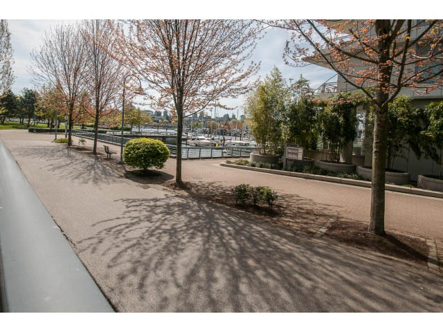 Furnished patio with tree shadows and city view. - 106 - 633 Kinghorne Mews, Vancouver Downtown