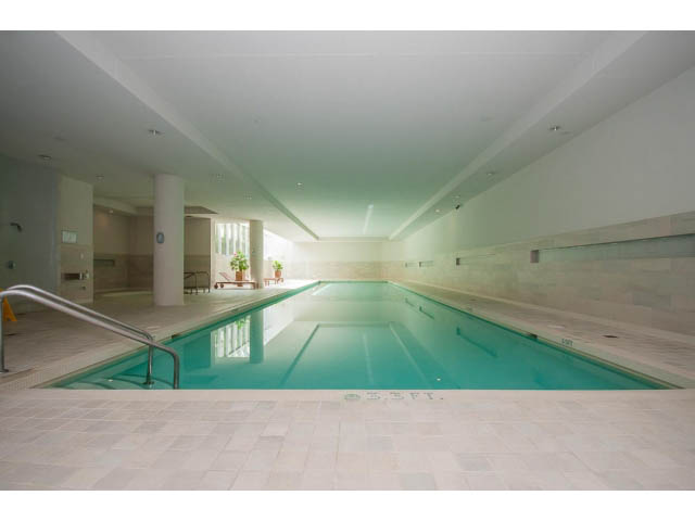 Spacious, modern indoor pool area with tiled flooring and sleek railings. - 106 - 633 Kinghorne Mews, Vancouver Downtown