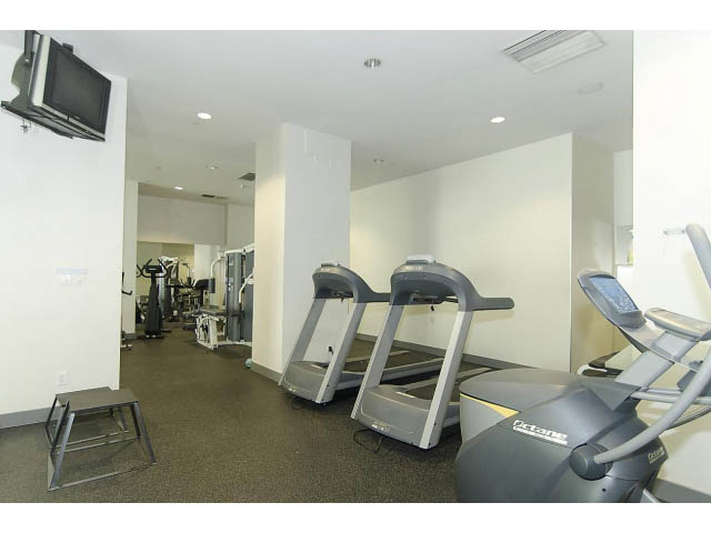 Furnished fitness room with treadmills and ellipticals. - 106 - 633 Kinghorne Mews, Vancouver Downtown