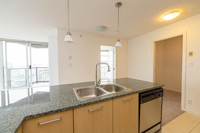 Bright kitchen with granite countertops, stainless steel sink, and city view. - 2504 - 1199 Seymour Street, Vancouver Downtown