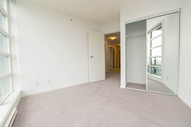 Spacious living room with sliding glass door and city view, ready for furnishings. - 2504 - 1199 Seymour Street, Vancouver Downtown