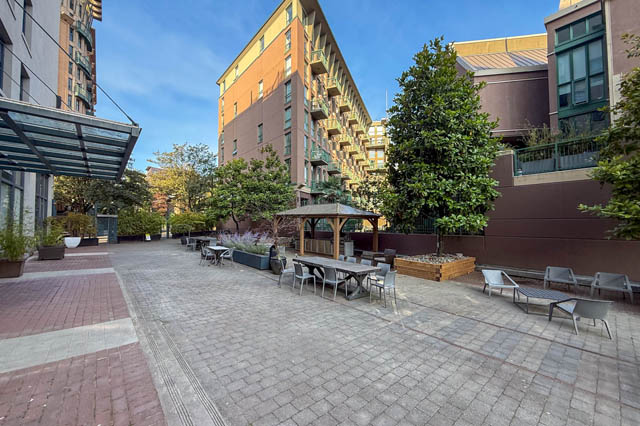 Spacious courtyard with outdoor seating and lush greenery, perfect for relaxation. - 221 - 55 E. Cordova, Vancouver Downtown