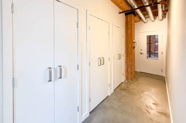 Spacious hallway with exposed beams and polished concrete floors, leading to a 1-bedroom loft. - 221 - 55 E. Cordova, Vancouver Downtown