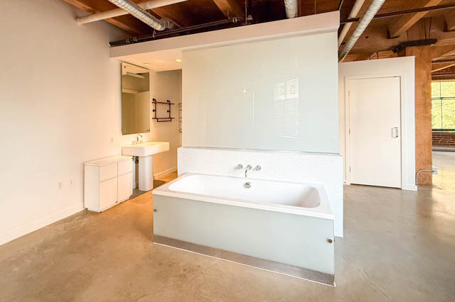 Spacious loft bathroom with concrete floors and modern fixtures. - 221 - 55 E. Cordova, Vancouver Downtown