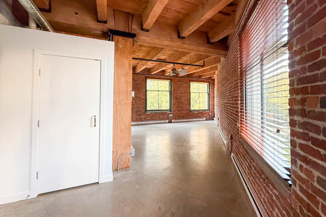 Spacious loft with exposed brick walls, concrete floors, and wooden beams, perfect for urban living. - 221 - 55 E. Cordova, Vancouver Downtown