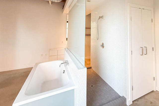 Spacious bathroom with white mosaic tiles and modern fixtures. - 221 - 55 E. Cordova, Vancouver Downtown